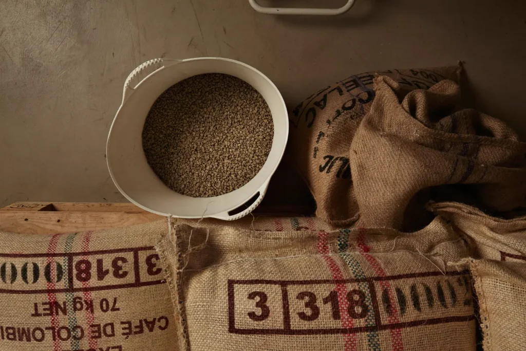 Raw green coffee beans from white plastic basket